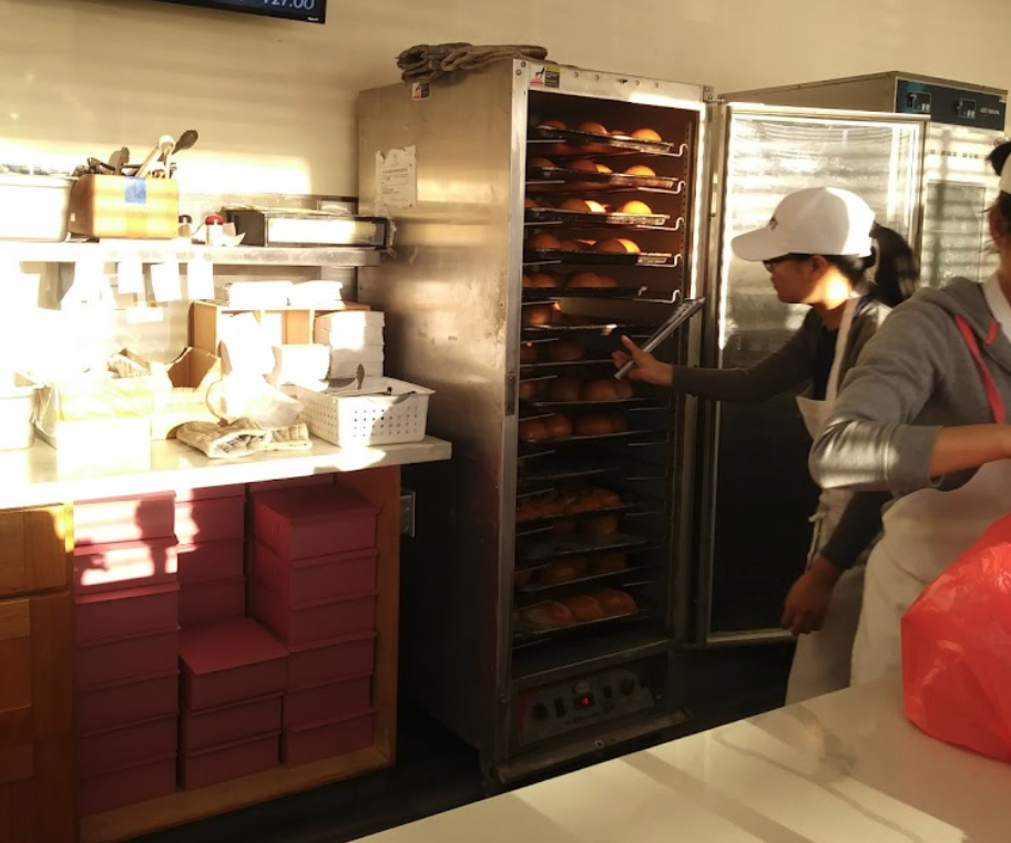 Steamed pork buns and pastries in a bakery box